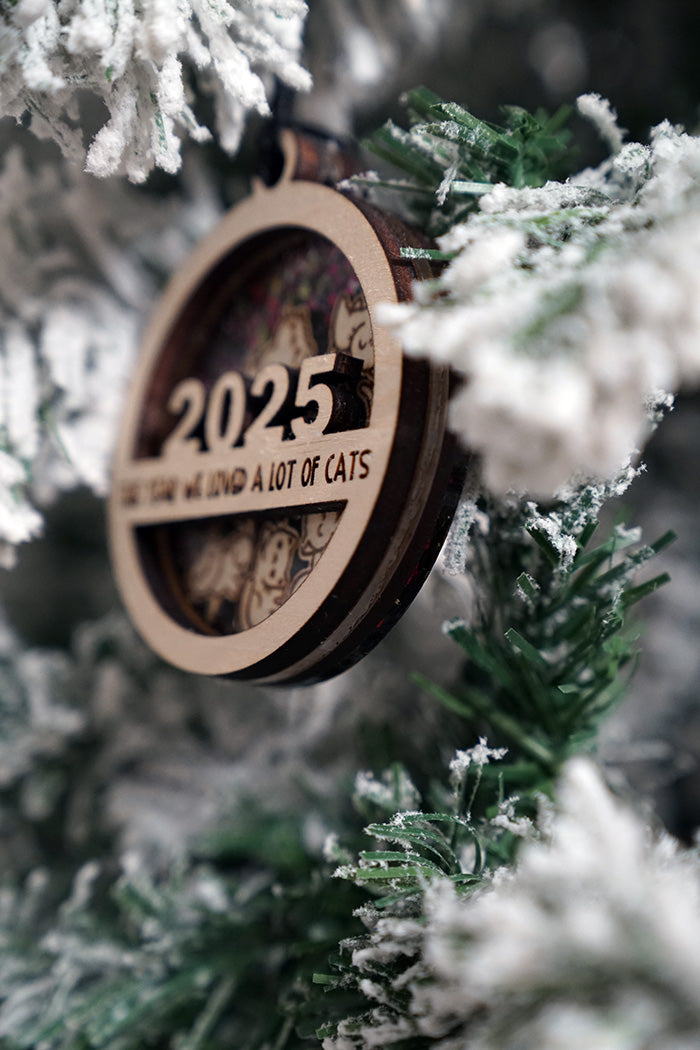 Wooden ornament with '2025 We love a lot of cats'